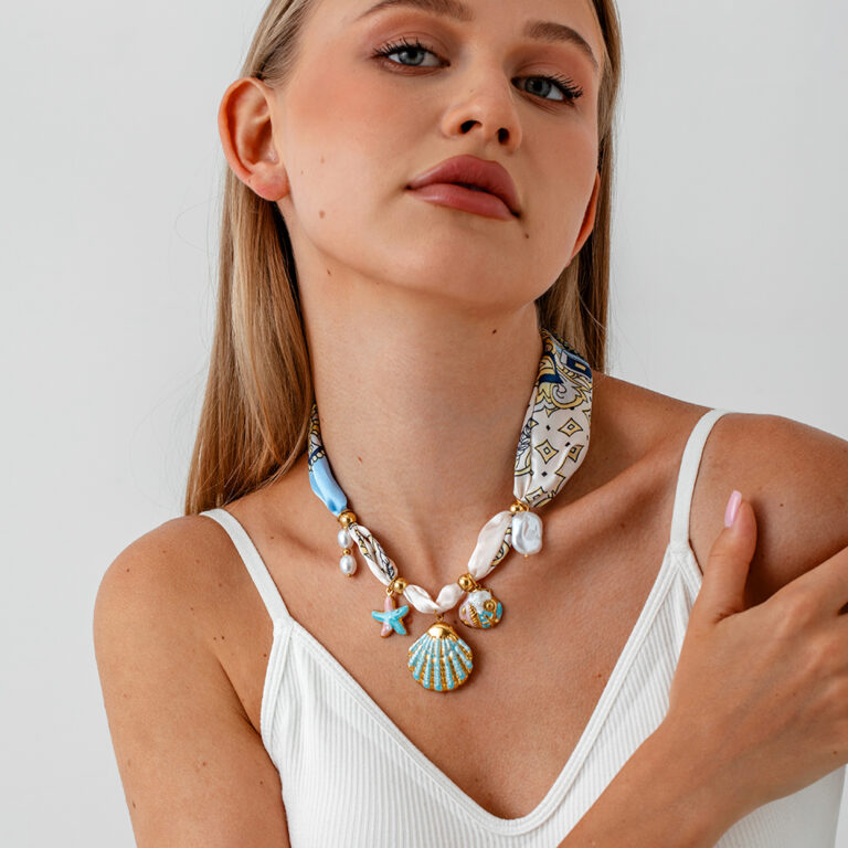 Model wearing a statement shell charm necklace